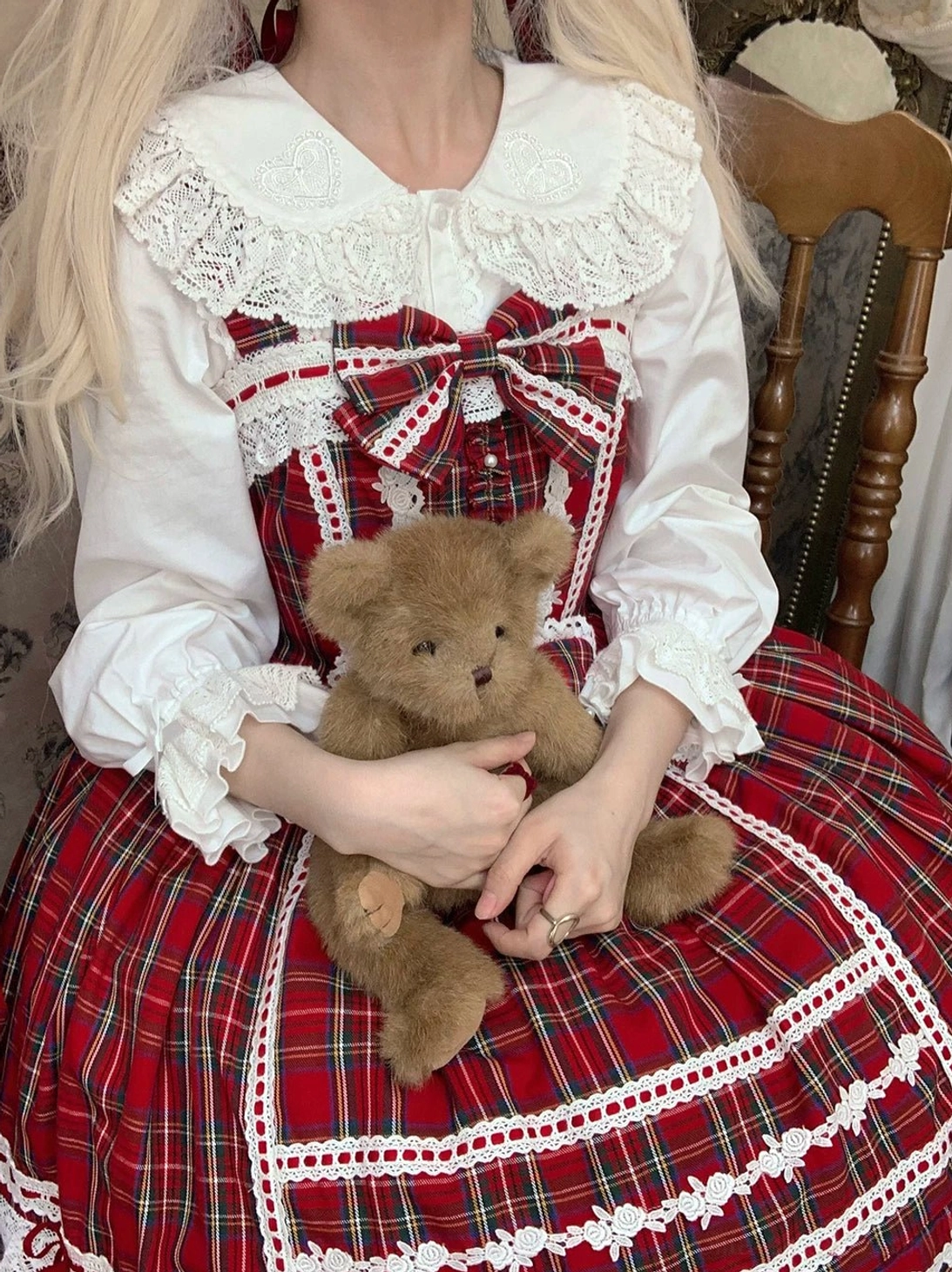 model wearing white lolita blouse with red tartan dress coordinated outfit teddy bear vintage dining chair sweet fashion
