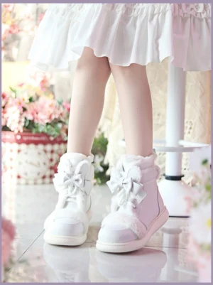 All-white kawaii lolita ankle boots with satin bow laces and soft fleece collar, side low view on model wearing white frilly mini skirt with floral backdrop