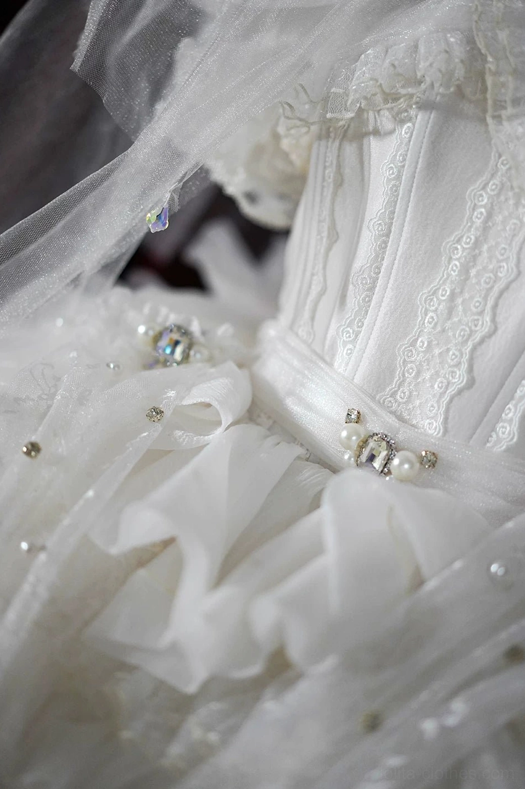 White Lolita bridal veil gloves with rhinestone bow set lace-trimmed corset bodice detail closeup view