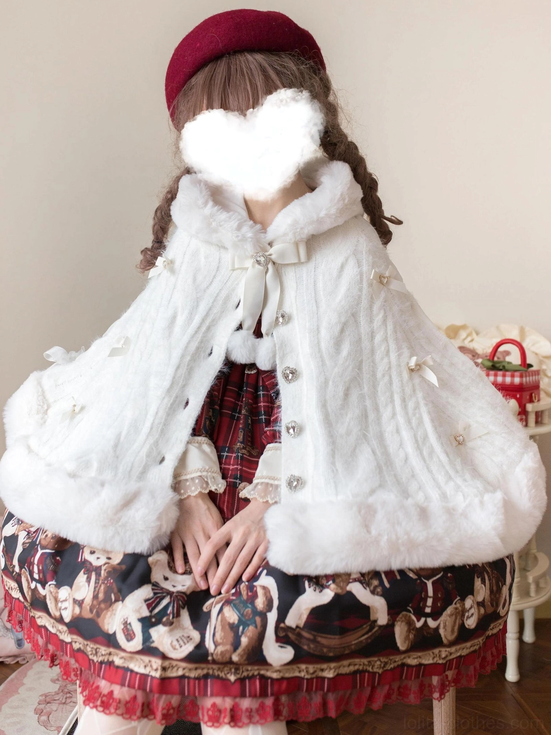 White faux fur lolita winter cape coat sitting partial front view showing soft rounded plush collar, paired with bear-print ruffled lolita skirt on seated model