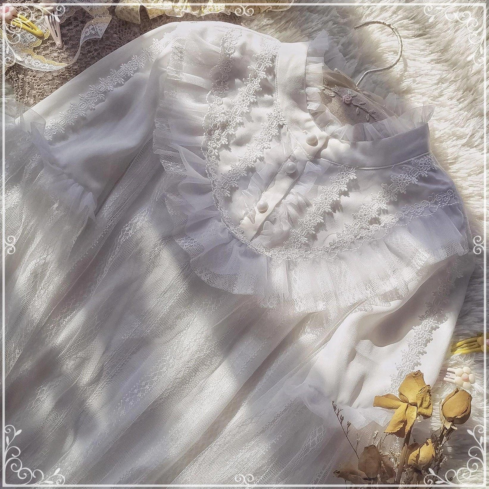 Close-up flat lay of white lolita chiffon blouse showcasing soft sheer fabric, ruffled stand collar, and lace-trimmed button closure with layered ruffle details