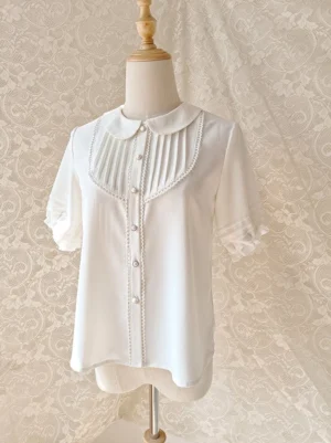 elegant white lolita chiffon short blouse with peter pan collar ruffled sleeves vintage lace backdrop front three quarter view on dress form