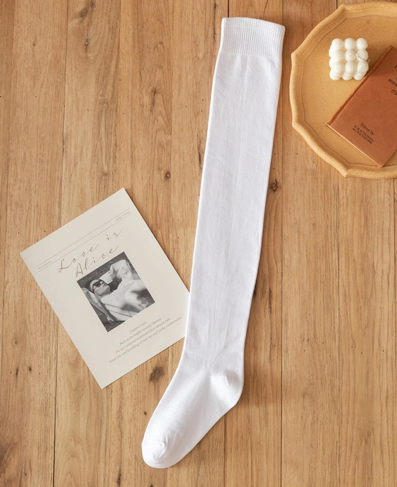 Single white lolita cotton knee stocking flat lay wooden table decorative postcard props straight tube design