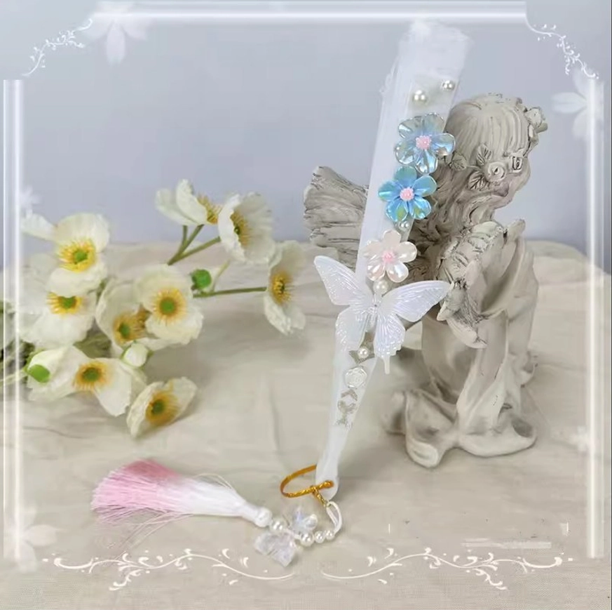 Closed white lolita folding fan side view with blue gradient flower decor white butterfly ornament and pink-white gradient tassel with bead pendant styling