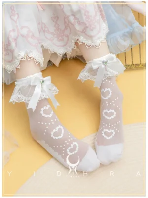 White sweet lolita heart-print ankle socks with detachable lace cuffs and satin bow, worn with pink embroidered lolita dress, overhead close-up view showing sheer fabric and cute kawaii aesthetic