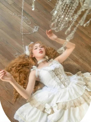white gothic lolita jumper skirt overhead flat lay shot showing corset lace-up front tiered ruffles gold trim and bowknot detail