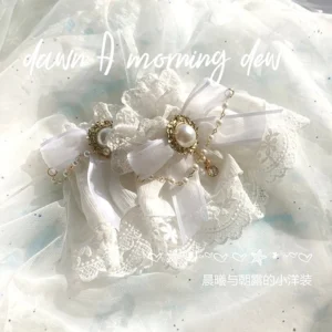 white lolita layered lace wrist cuffs with satin ribbon bows and vintage gold chain details on light blue tulle