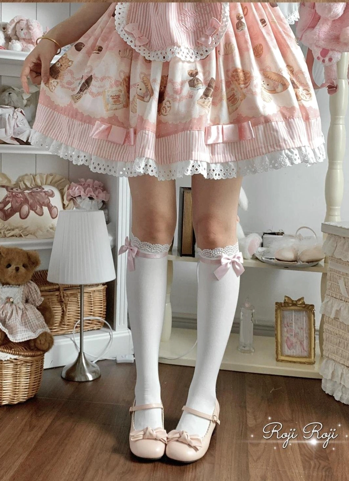 White lolita mid-calf socks with tiny bow and lace cuff worn with pink Mary Jane shoes full front view matching pink sweet lolita dress