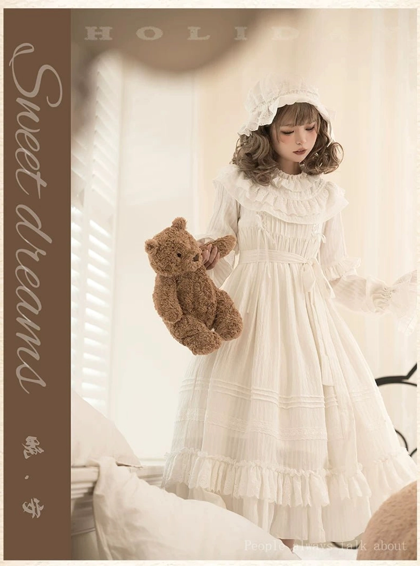 Front view of white lolita one-piece dress with matching bow-decorated bonnet and teddy bear prop, capturing the complete doll-like sweet lolita coordinate