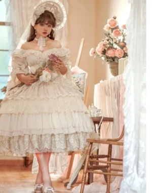 Cream white off-shoulder Lolita OP dress with sweetheart neckline and lace-trimmed multi-layered skirt displayed on model in vintage indoor sitting room holding flower bouquets