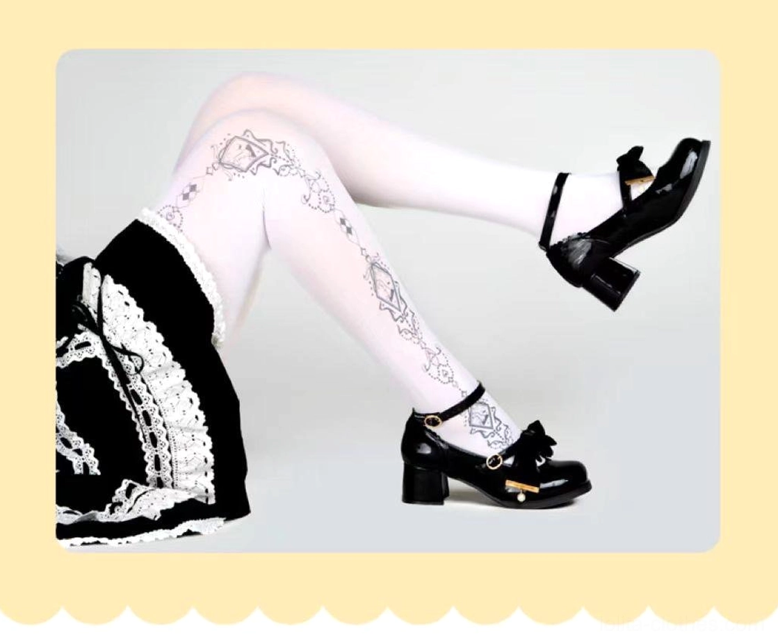 Lying down side leg perspective showing intricate black diamond and vine prints on sheer white Lolita pantyhose with Mary Jane shoes