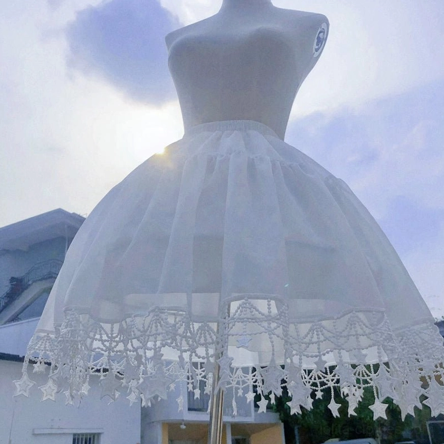 Ethereal white Lolita petticoat with star pendant lace trim sunlit outdoor display blue sky background