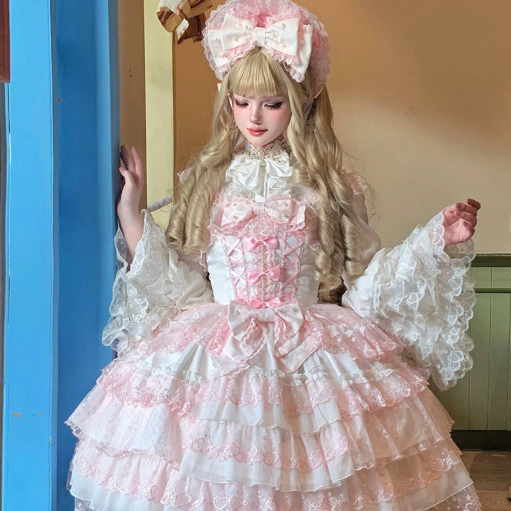 White Sweet Lolita princess blouse medium close-up front view showing lace Peter Pan collar, tiered puffed sleeves, and layered lace skirt with bow detail