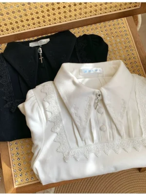 White lolita sweater flat lay showing delicate lace embroidery on pointed collar front button closure and puff sleeves with decorative details