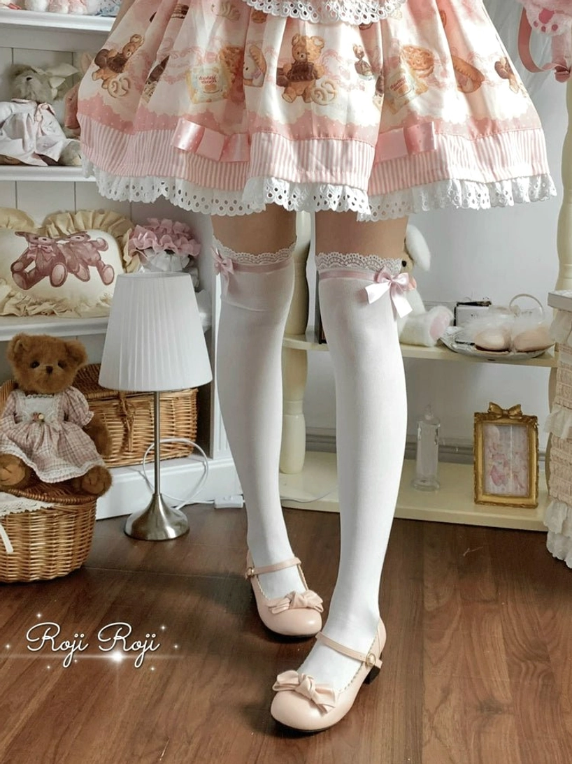 White lolita thigh-high socks with full-length coverage lace and bow details showcasing sock silhouette side low angle view sweet coordinate