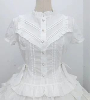 White elegant Lolita short sleeve waist-defining blouse with ruffled stand collar, pearl button front placket, and side bow sashes on dress mannequin front view