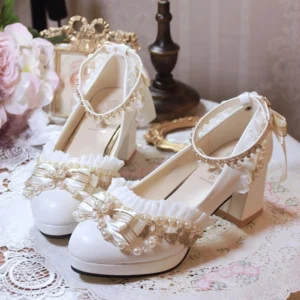 White handmade Lolita wedding heel shoes featuring pearl and gold beaded bows displayed on vintage lace tablecloth with pink roses and retro ornaments three-quarter front view