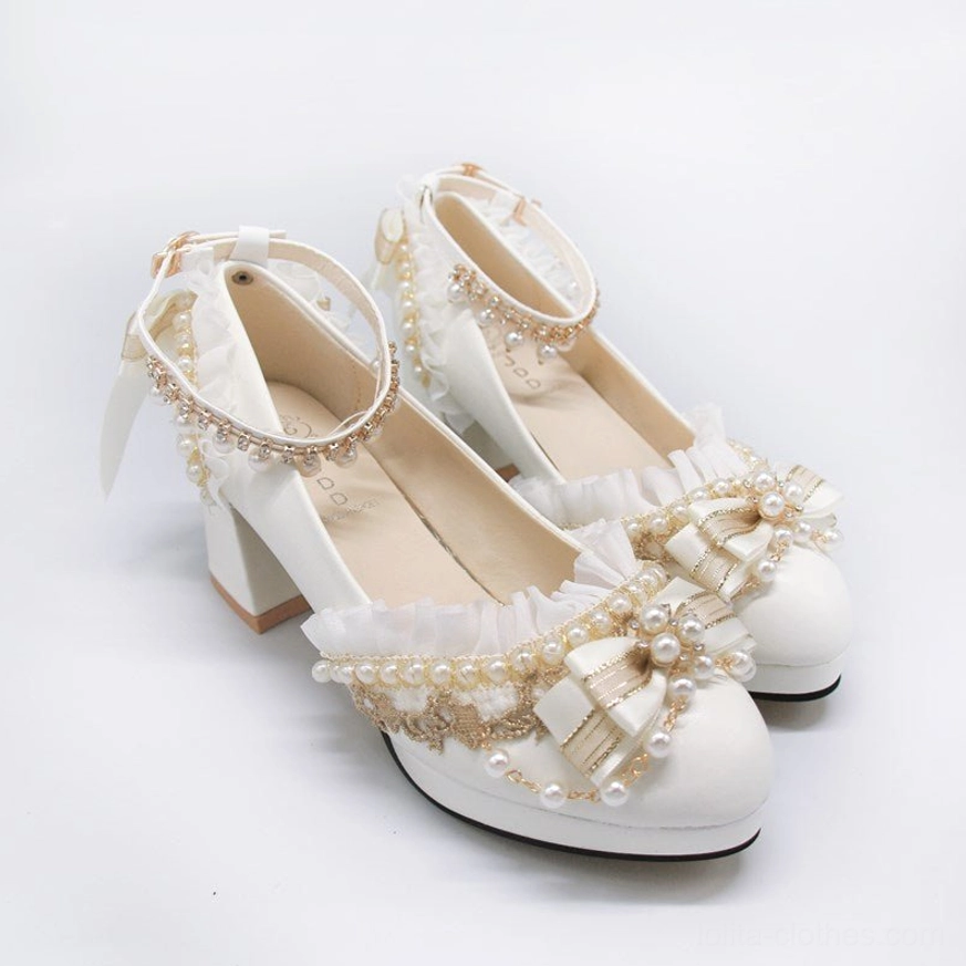 Side close-up view of white handmade Lolita wedding heel shoes on plain studio background displaying block high heel smooth white leather upper full decorative trims vamp