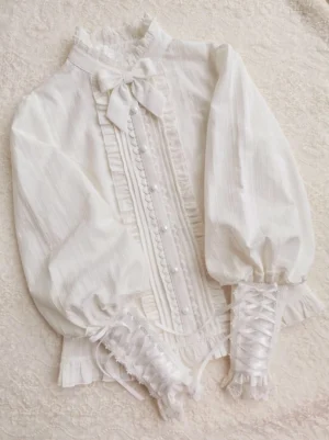 White vintage lolita mutton sleeve blouse with ruffled stand collar bow flat lay overhead view showing full silhouette dramatic lantern sleeves and lace-up pearl-button front placket