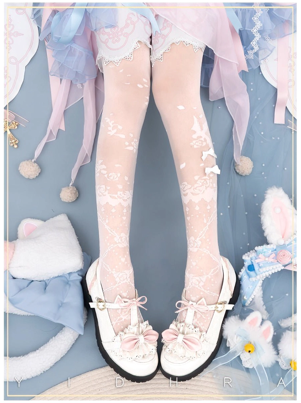 Overhead flat shot of white Lolita floral sheer tights featuring delicate vine and botanical patterns, paired with white bow Mary Jane shoes, cat ear hair props, and pastel Lolita skirt styling