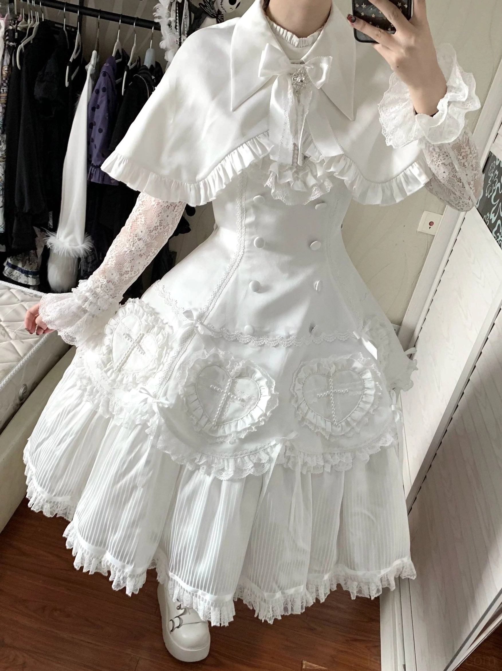 White Nocthymn Cross Gothic Lolita dress with detachable capelet close-up front mirror selfie pleated layered skirt ruffled edge capelet bow neck