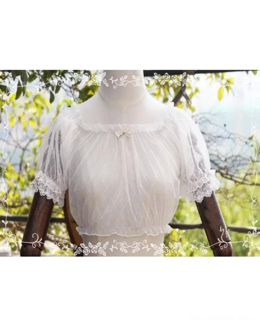 White off-shoulder lolita inner blouse with mini neck bow detail, lace-cuffed short sleeves, and cropped sheer design, slightly side front view on dress form with natural tree branch background