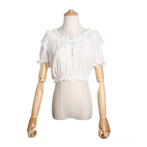 White off-shoulder elasticated lolita cropped blouse with short puff sleeves and lace trim ruffles displayed on wooden dress form full front studio view