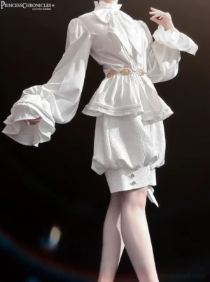 White Ouji lolita outfit featuring retro gothic metal waist chain worn around waist on model wearing trumpet sleeve ruffled shirt and bubble shorts back three-quarter view