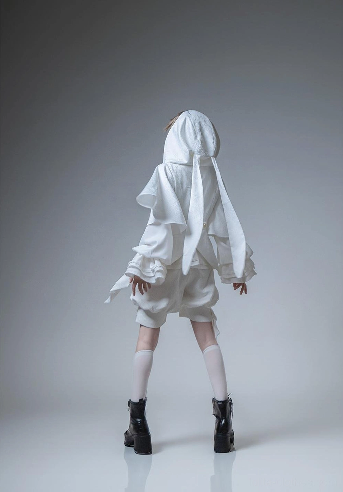 White Ouji Lolita hooded jacket and shorts set back view showing rear silhouette long ear hood accents relaxed shorts fit and waist sash back detail