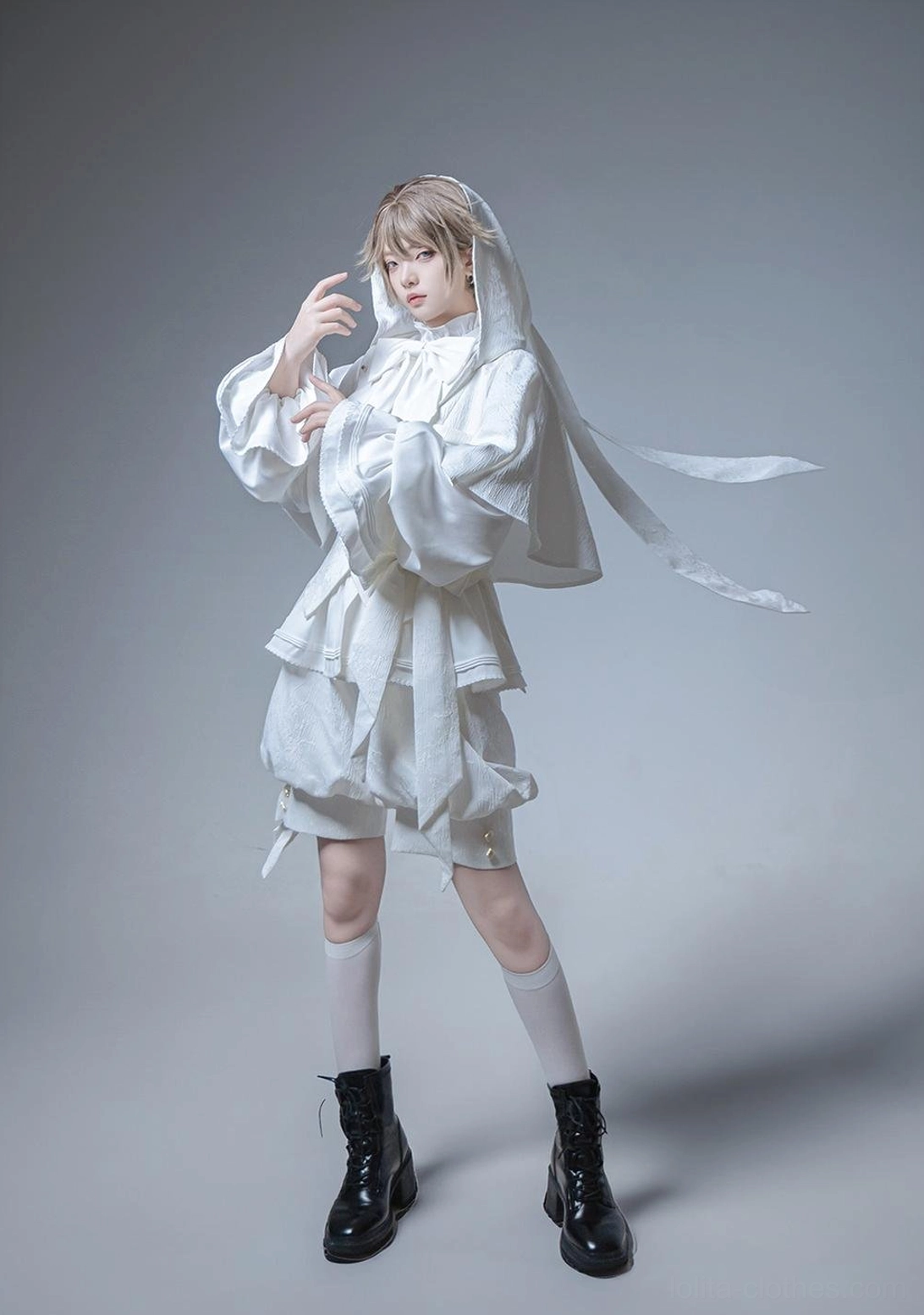 White Ouji Lolita hooded jacket and shorts set side three-quarter view highlighting floating hood ear ribbons tailored shorts with side straps and black platform boots