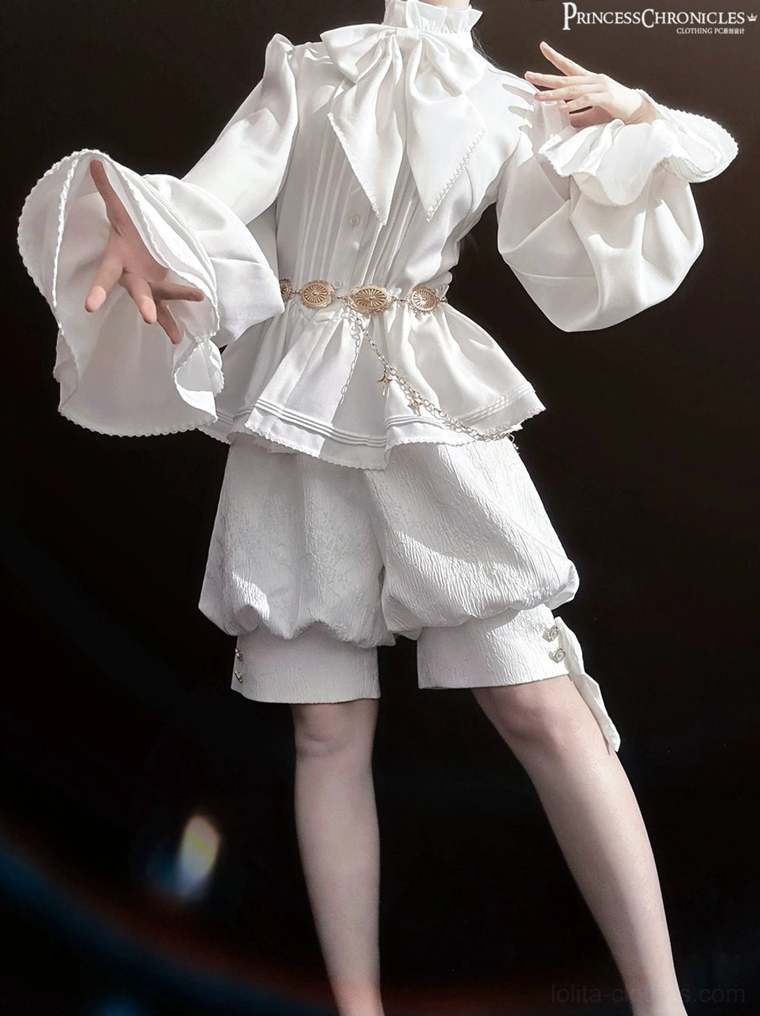 Side front perspective of white Ouji lolita outfit showing ruffled peplum shirt detail and tailored bubble shorts with gothic metal waist chain worn at waist