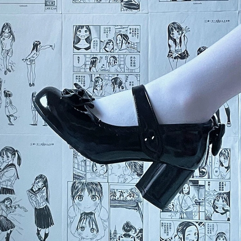 White patent leather Lolita Mary Jane high heels with decorative front and rear bow elements heart-shaped ankle strap buckle detail