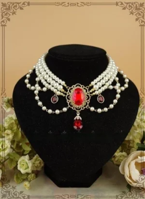 Multi-layer white pearl Lolita choker with dark red teardrop gemstone pendant and matching side gems, displayed on black jewelry bust with vintage floral backdrop and gold-toned metal frame