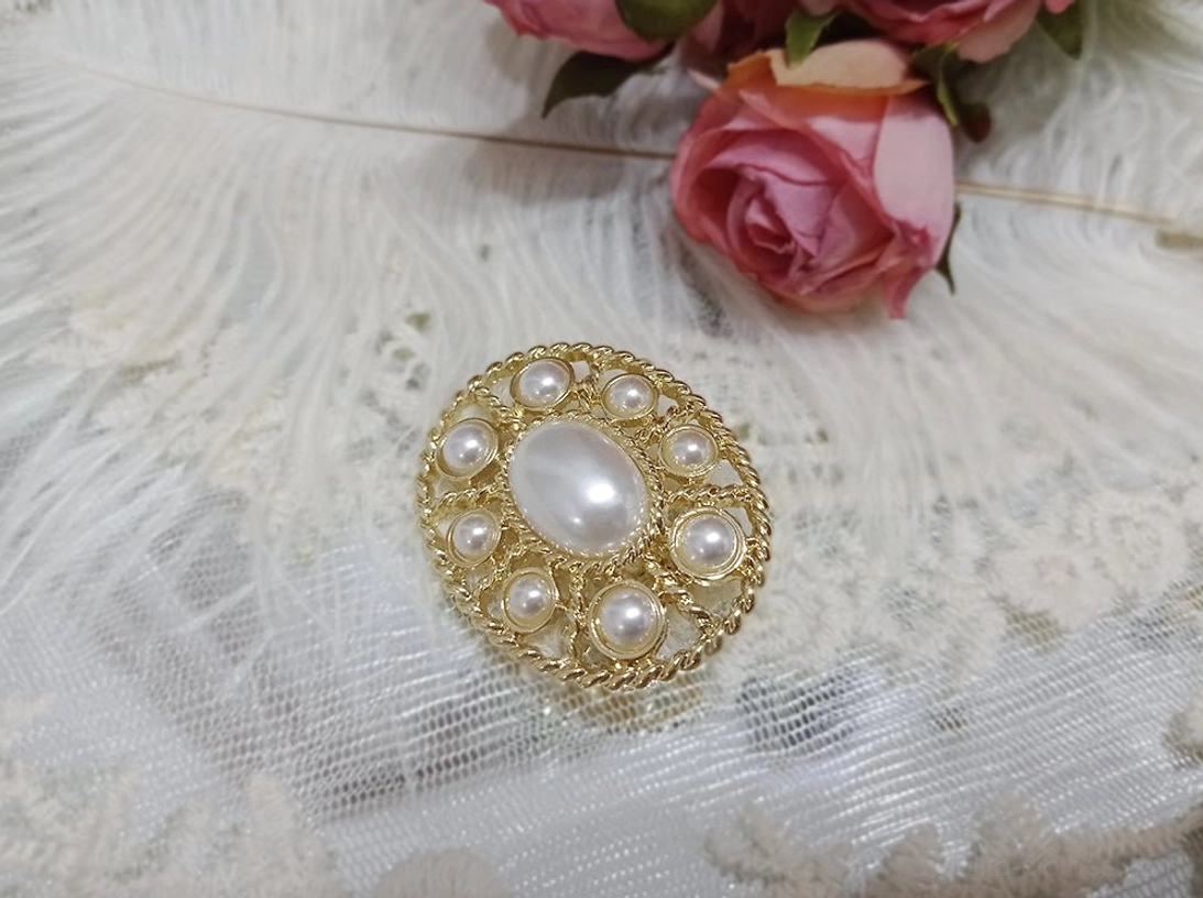 White pearl Lolita brooch with a large central imitation pearl and surrounding pearl embellishments on an antique gold setting