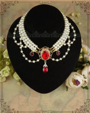 Double-layer white pearl Lolita choker with red gem ornaments, flat display view on black velvet bust stand with vintage flower and antique paper background, ornate gold metal center piece