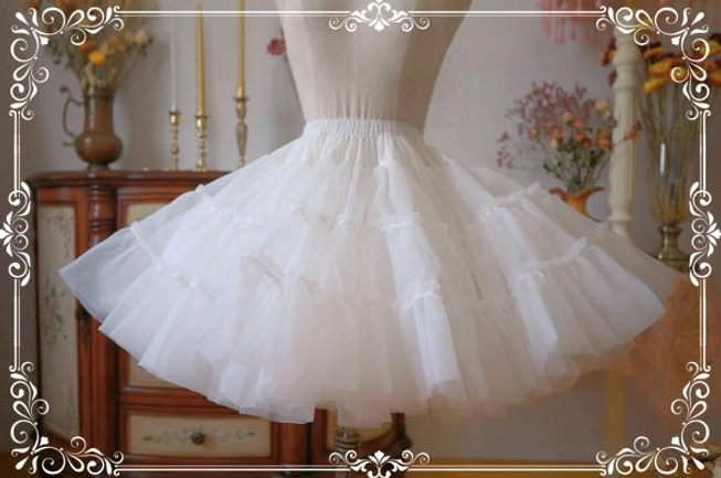White lolita petticoat side three-quarter view on dress form displaying full fluffy A-line silhouette with tiered ruffled tulle construction