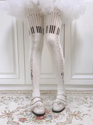 White piano keys velvet lolita tights with black musical staff print paired with white ruffled lolita skirt and beige mary jane shoes elegant vintage interior styling