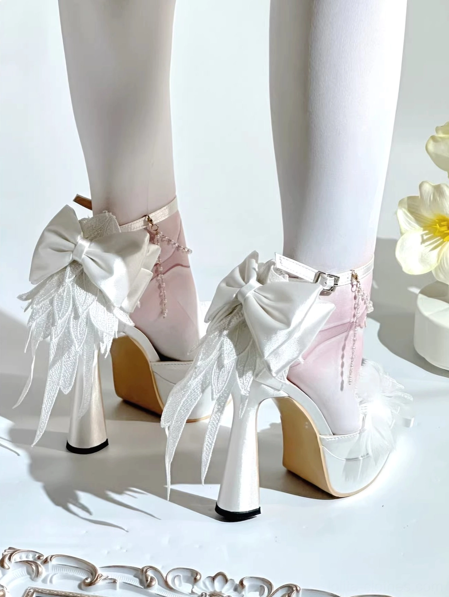 White-pink bow lolita platform high heel shoes with big white bow and feather decorations, pearl accents, gradient color upper, chunky heel, mannequin display with white sheer stockings and tulip props