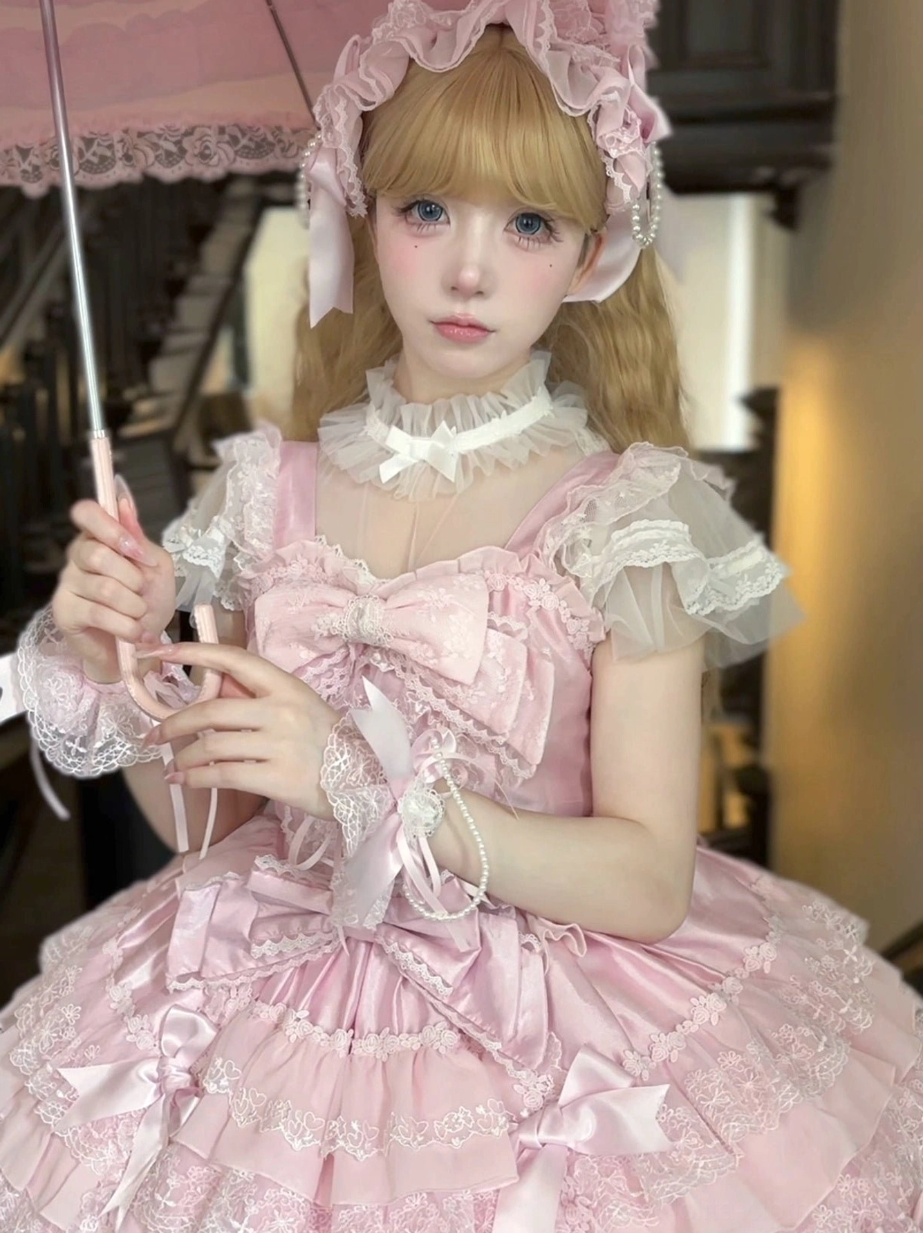 White and pink lolita jumper dress side view showing silhouette multi-layered ruffled skirt and detachable waist tie details