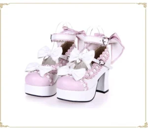 White and pink lolita platform high heels with ruffled lace trim ankle strap bow decorative golden frame front angled view