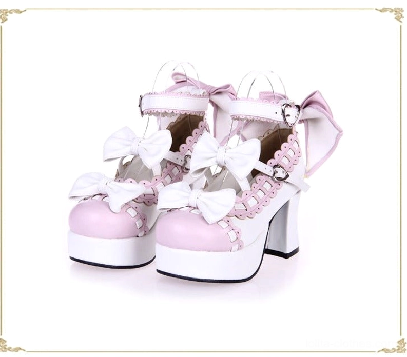 White and pink lolita platform high heels with ruffled lace trim ankle strap bow decorative golden frame front angled view