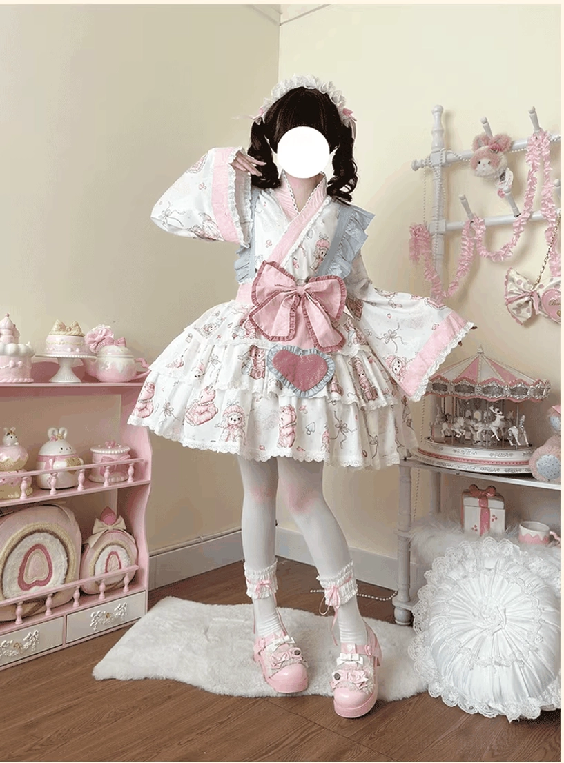 White and pink wa lolita kimono dress set three-quarter standing view, model in pastel sweet tea party bedroom, featuring moe bear and dessert printed fabric, wide Japanese collar and flared sleeves