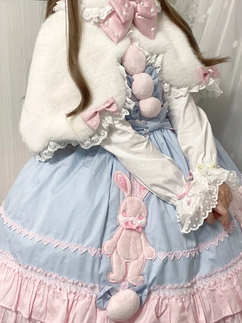 White plush Lolita cape with pink bow worn with blue bunny print dress back view on model