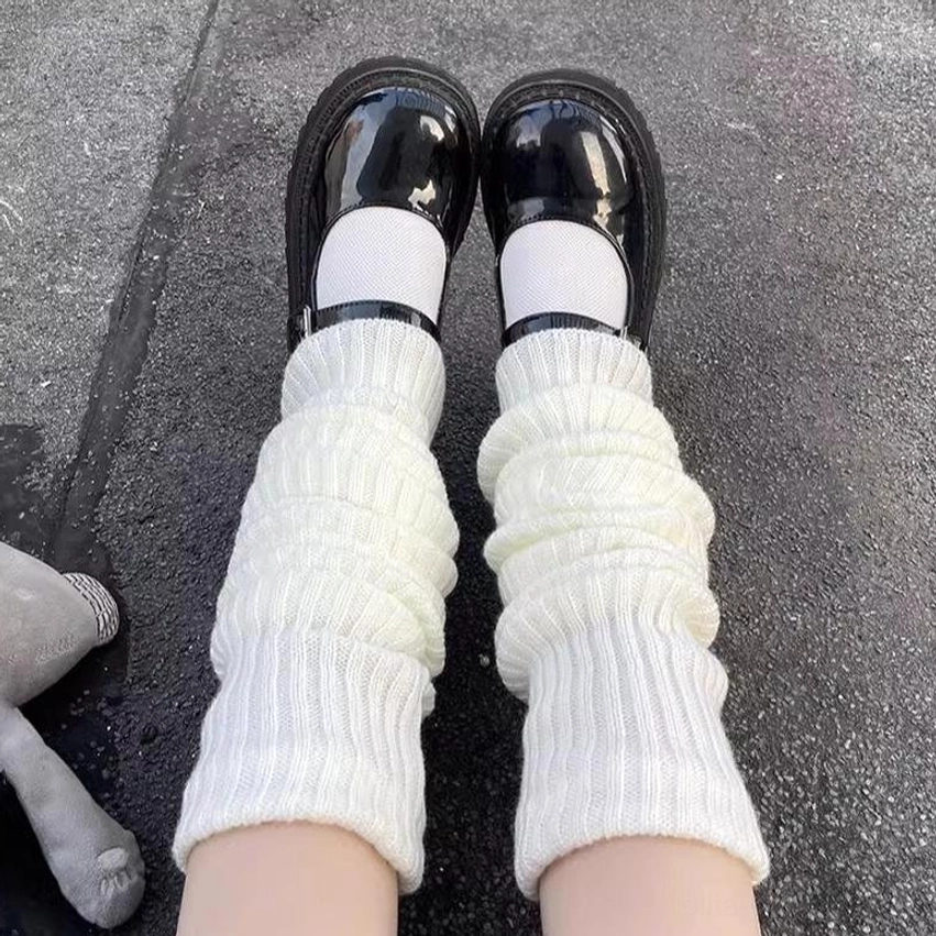 White ribbed lolita leg warmers top-down close-up feet lower legs concrete ground plush toy mary jane