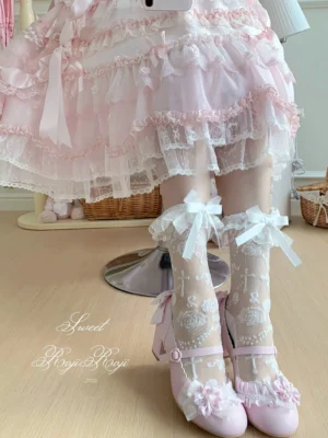 White sheer rose jacquard mid-calf lolita bow socks with white satin bows side view of model wooden floor studio wearing pink mary jane shoes