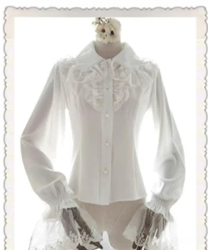 White classic Lolita chiffon blouse with delicate lace accents, pearl-style buttons, and layered bell cuffs, shown on decorated dress form displaying romantic vintage silhouette