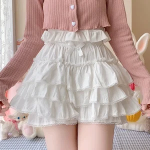 White layered ruffled lolita bloomers with lace trim high elastic waist worn with pink cardigan indoor checkered setting
