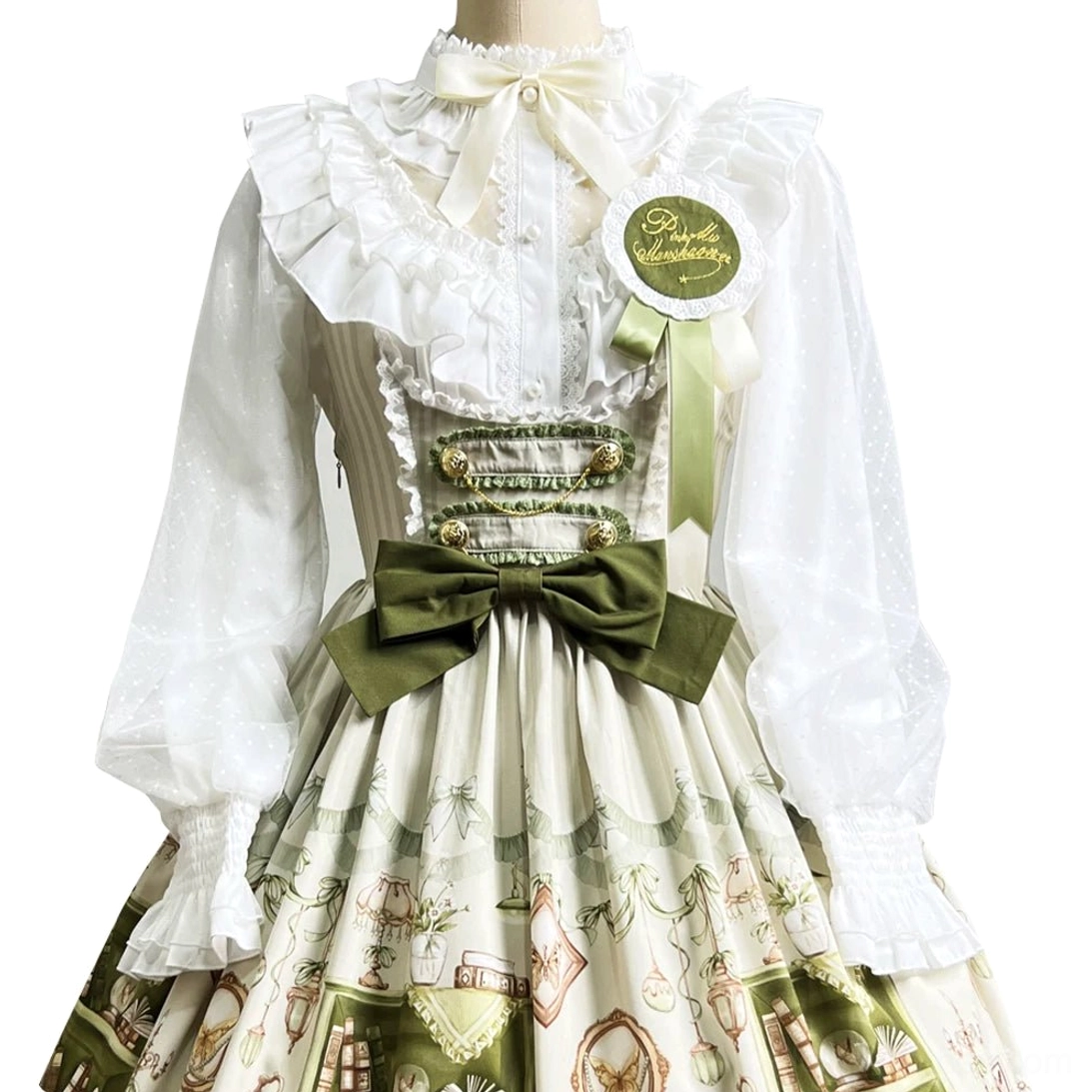 White ruffled long-sleeve blouse with polka dot pattern and decorative collar, shown on mannequin paired with bookstore print Lolita JSK
