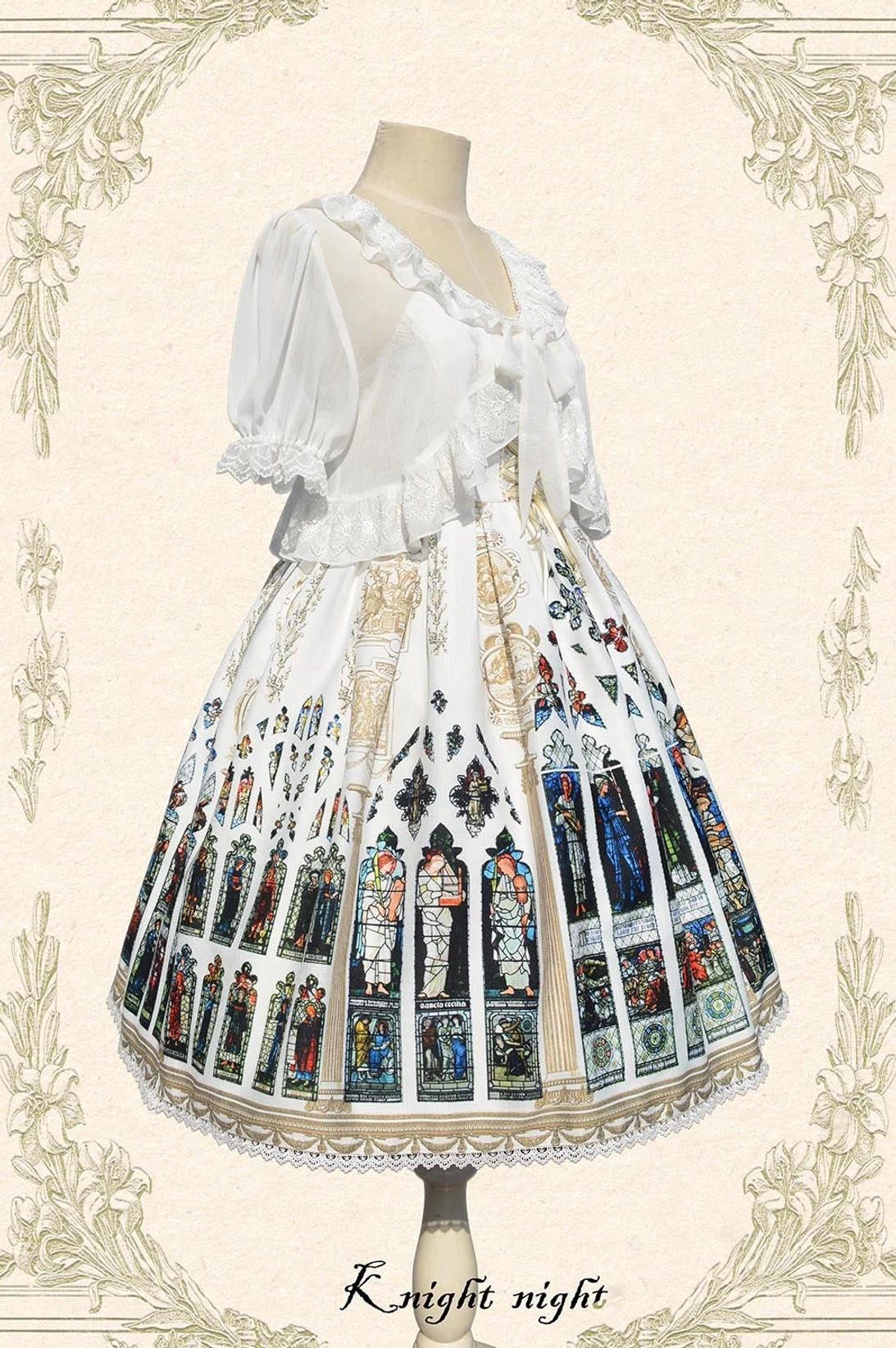 White Saint Priest Lolita coordinate set featuring ruffled short-sleeve bolero with front bow paired with matching JSK dress displaying full stained glass print and lace hem trim
