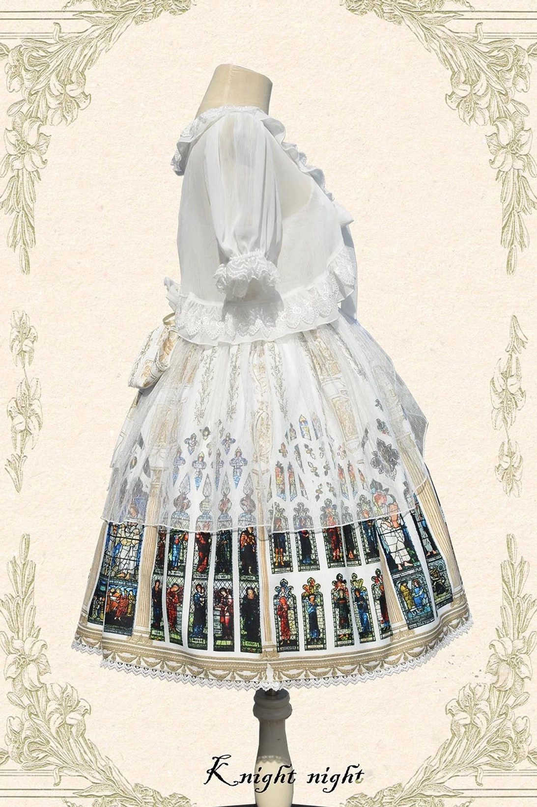 Back view of White Saint Priest Lolita coordinate set showing sheer puff short sleeves, ruffled collar bolero detail, back bow on JSK, and ecclesiastical stained glass skirt print